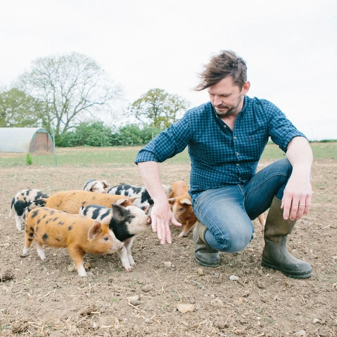 Jimmy Doherty with piglets in Jimmys Farm Jimmy Doherty crouching beside a caged moon bear at a former bear bile farm in South Korea
